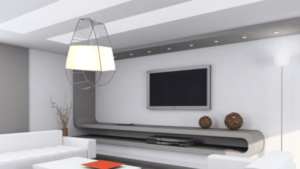 Lampe suspendue avec structure métallique ajourée et abat-jour blanc, installée dans un salon contemporain aux lignes épurées